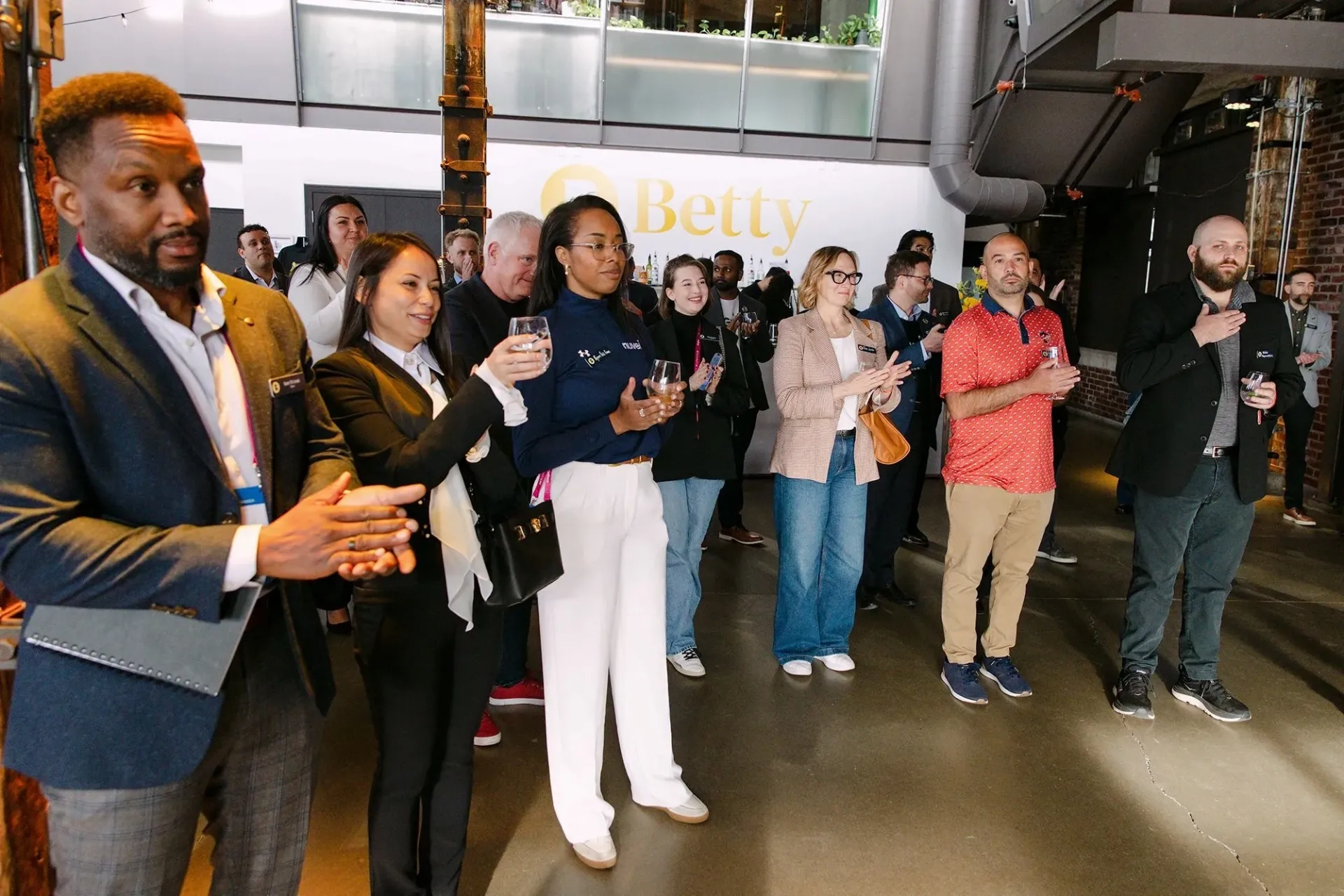 People gathered at a Betty branded company event.